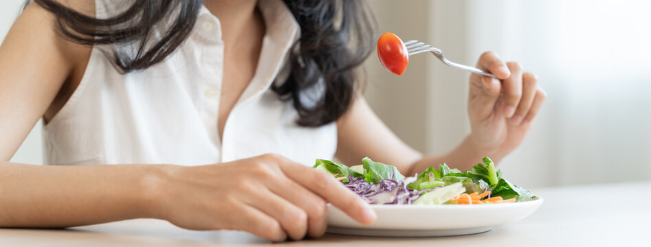 Diet, Dieting asian young woman or girl use fork at broccoli on mix vegetables, green salad bowl, eat food is low fat good health. Nutritionist female, Weight loss for healthy person.