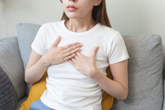 woman suffering at chest from acid reflux disease