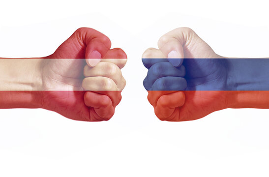 Russia and Austria Flags on Opposing Fists Representing International Conflict