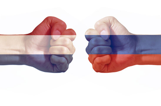 Russia and Netherlands Flags on Opposing Fists Representing International Conflict