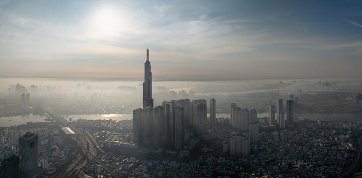 Landmark 81 and city towers silhouetted in bright haze, Ho Chi Minh City, Vietnam