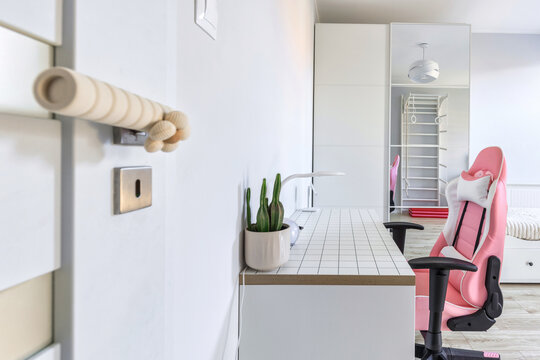Childs bedroom in white and gray colors with a desk.