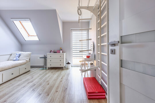 Childs bedroom in white and gray colors with a desk.