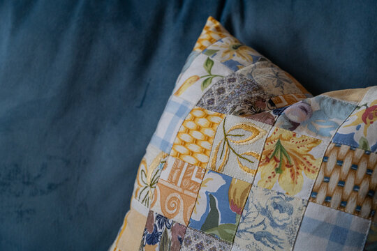cushion on sofa close up blue and yellow patch work