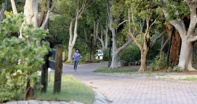 Lifestyle videos outdoor of people doing activities, running on park pathway, woman exercising outdo