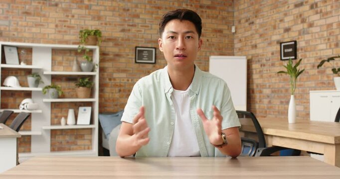 Close up of people talking to the camera, businessman explaining while sitting at desk in office