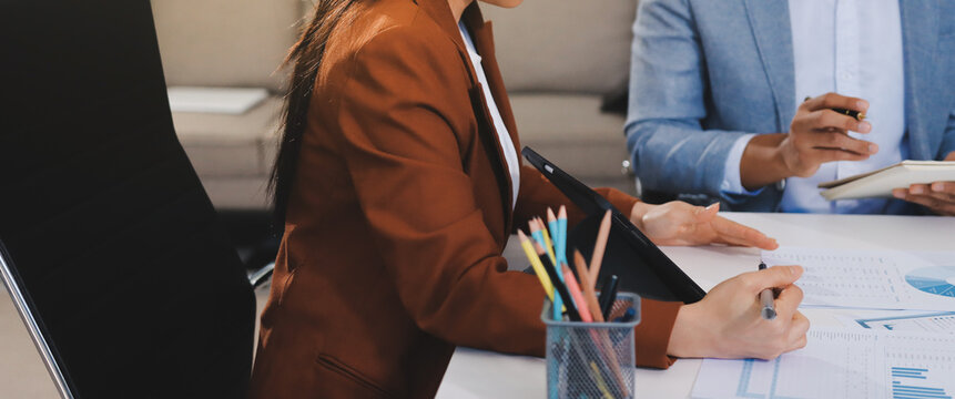 Business professional analyzing financial data on digital tablet dashboard with calculator and laptop, representing accounting software, ERP system integration, performance monitoring.