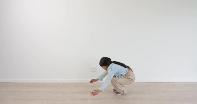 High-speed photography for dynamic scenes, woman in denim jacket and beige pants in empty room, pick