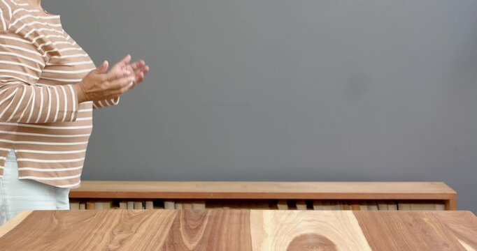 Close up of people talking to the camera, clapping hands, person standing by table in home