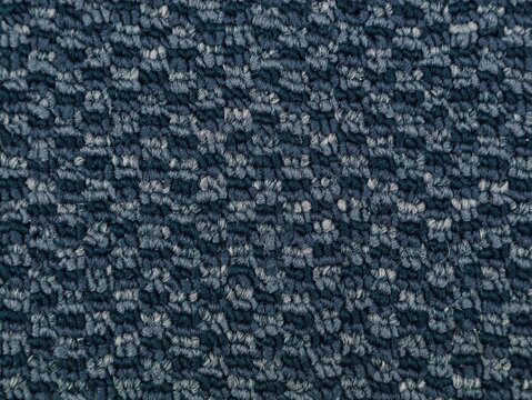 High resolution close up shot of a dark blue patterned carpet texture. Ideal for interior design backgrounds, flooring material samples, architectural details, and textile pattern wallpapers