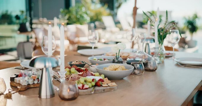 Party, food or charcuterie board outdoor with candles, sushi arrangement or table setup at gathering. Celebration, nutrition or catering with platter, appetizer or snack selection in backyard event.