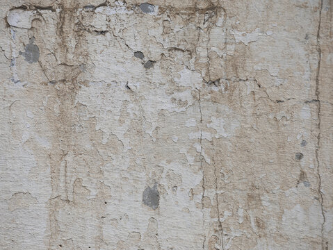 Weathered concrete wall texture with peeling plaster