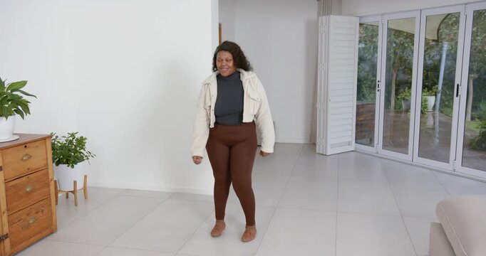 High speed photography for dynamic scenes, smiling woman in casual outfit standing in modern living