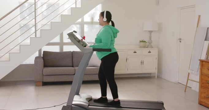 Lifestyle videos indoor of people doing activities at home, exercising on treadmill, woman wearing h
