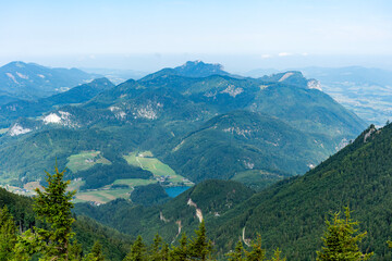 Fototapeta premium Aerial view of mountain landscape. Landscape panorama. Misty landscape with mountain lake in nature. Mountain peak aerial view. Aerial misty landscape. Scenic nature over lake
