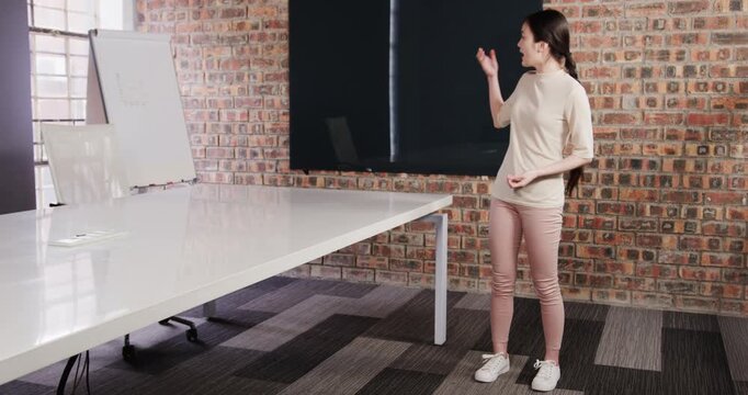 Close up of people talking to the camera, presenting in room, woman standing near table