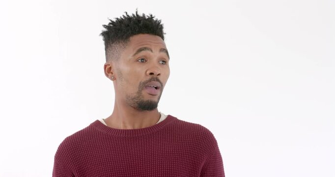 Posing against white background, confident man in casual sweater showing curiosity