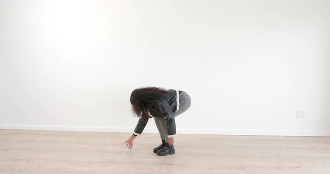 Gesturing and interacting with invisible object, woman in stylish outfit indoors