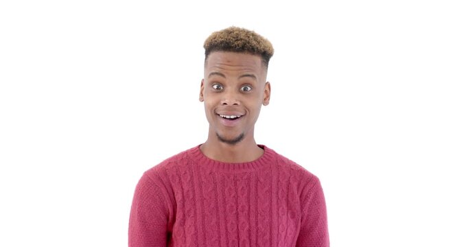 Surprised young man in red sweater expressing shock against white background