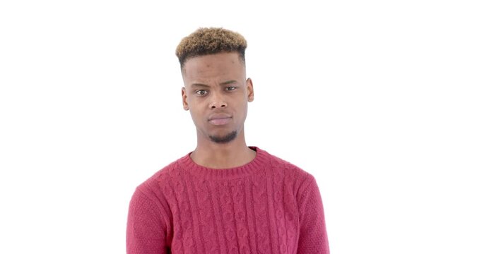 Young man in red sweater expressing confusion against white background