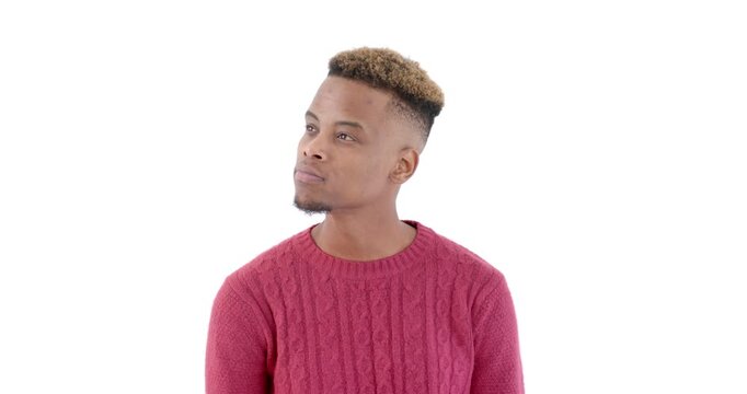African American man in red sweater looking thoughtful against white background