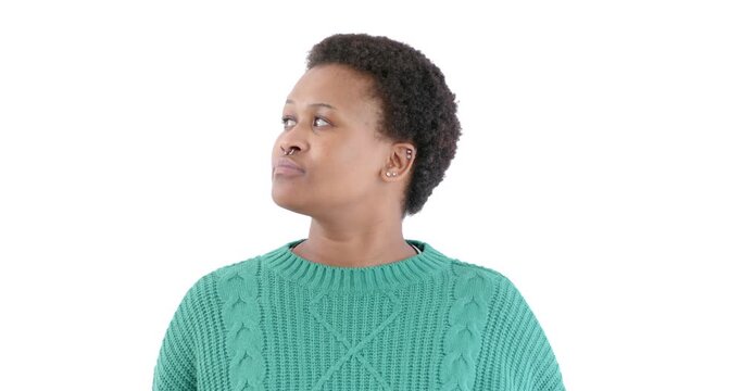 Looking thoughtful and pensive, African American woman in green sweater gazing away