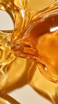 Viscous golden liquid with swirling textures and light reflections