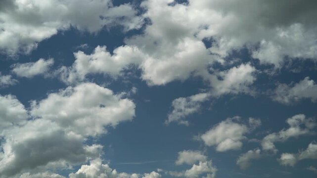 White Cumulus Clouds Against a Deep Blue Sky
