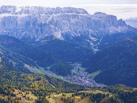 The peaks of the Sella Group, below the village of Selva, drone shot, Val Gardena, Dolomites, Autonomous Province of Bolzano, South Tyrol, Italy