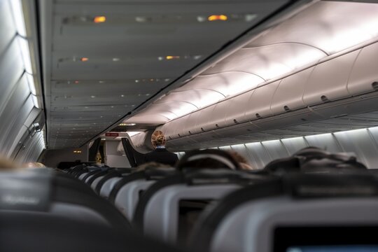 Interior of an aircraft, stewardess, rows of seats in an aircraft
