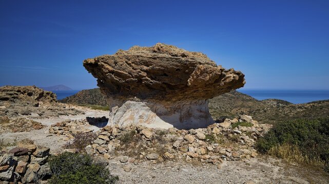 Distinctive rock formation with dry vegetation on the coast with intense sky, mushroom rocks, mushroom rock, bizarre rocks, rock formation, Skiadi, Kimolos, Cyclades, Greek Islands, Greece