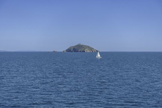 Sailing ship and Faro di Palmaiola, ferry trip to Piombino, Province of Livorno, Italy