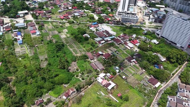 Aerial view shows tall buildings next to traditional homes at Bukit Mertajam