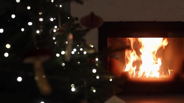 Atmospheric Christmas eve with Burning Fireplace and glowing christmas tree Lights video. Holiday Magic, cozy winter home. hygge Warm Evening. 