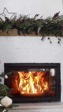 Video of Cozy Burning Fireplace with Decorated Christmas mantel. Winter Comfort, Warm Home. Christmas Eve, Hygge Lifestyle. Domestic Relaxation