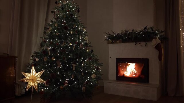 Warm Fireplace Burning in Background with Decorated Christmas Tree, video. Winter Evening, Cozy Home Atmosphere, Christmas Holiday Relaxation, Peaceful Night,