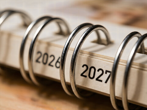 Two hanging calendars showing years 2026 and 2027 on a wall