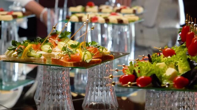 Fruits, cakes, and sweets on a festive banquet table before a business event or other celebration. Sweet drinks for guests.