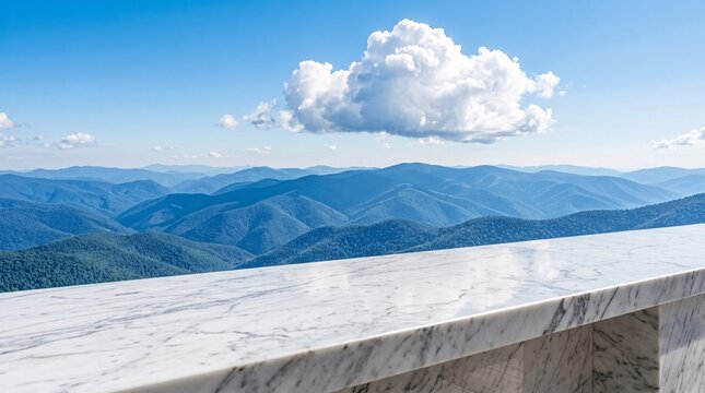 White marble countertop with grey veining overlooks rolling blue mountain peaks fading into distance beneath a single bright cloud