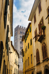 Fototapeta premium Lucca, Italy: old street with the belfry of the San Frediano church