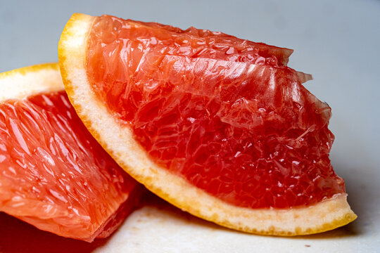 Juicy fresh red grapefruit slices close-up.