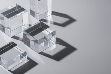 Obraz premium Transparent Glass Cubes on Grey Background with Shadows