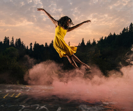 South Asian woman jumping outdoors