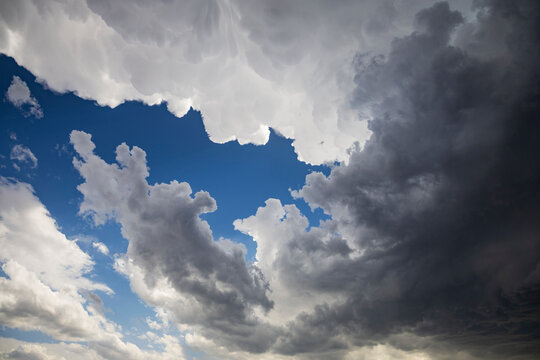 Storm clouds with anvil edge and blue sky in crossroads, new mexico