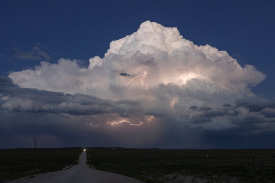 Supercell lightning storm over rural road in nara visa, new mexico