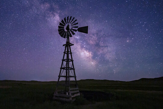 Windmill under Milky Way night sky in Nebraska Great Plains