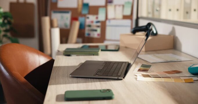 Empty, office and laptop at startup for ecommerce, logistics and color palette for fashion launch. Pc, sample and selection in workplace with pc, clothes collection and online retail for distribution