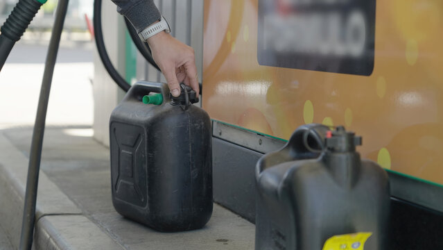 Filling-up the fuel container at gas station close-up