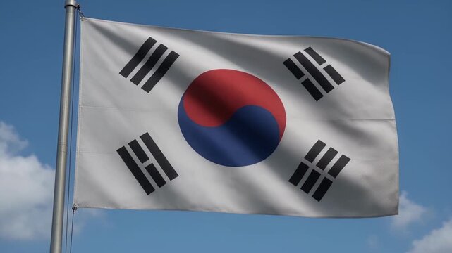 Politics - South Korean national flag waving proudly in the wind against a blue sky with white clouds