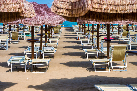 Pescara Beach Club With Thatched Umbrellas And Empty Sunbeds